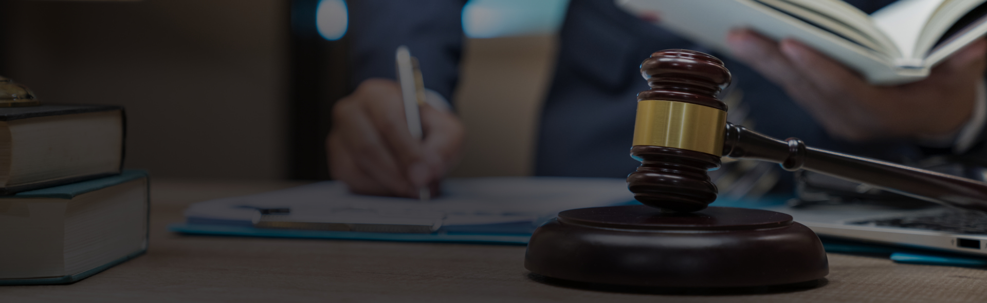 A gavel sitting on a desk with a round sound block