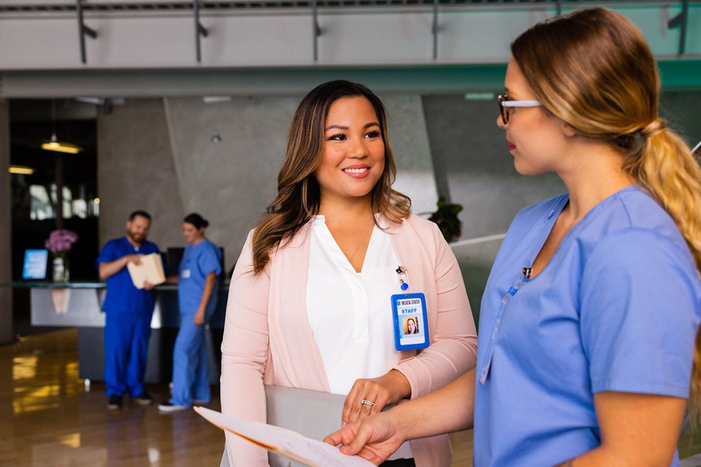 Nurses talking in a hospital lobby