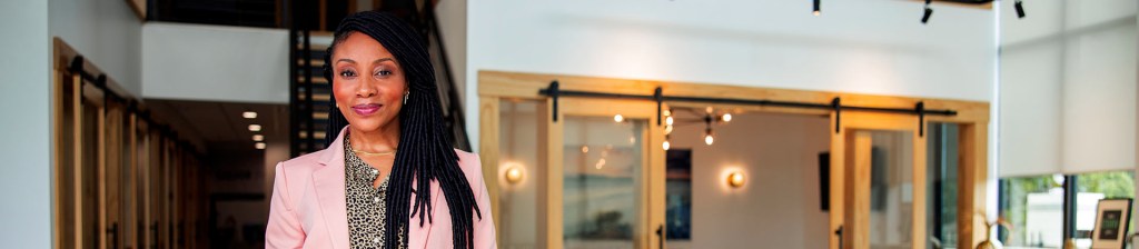 Woman in pink blazer in office