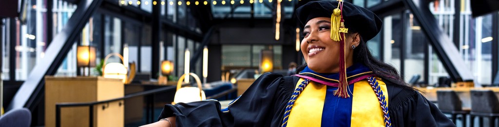 woman graduate smiling as she looks to her right