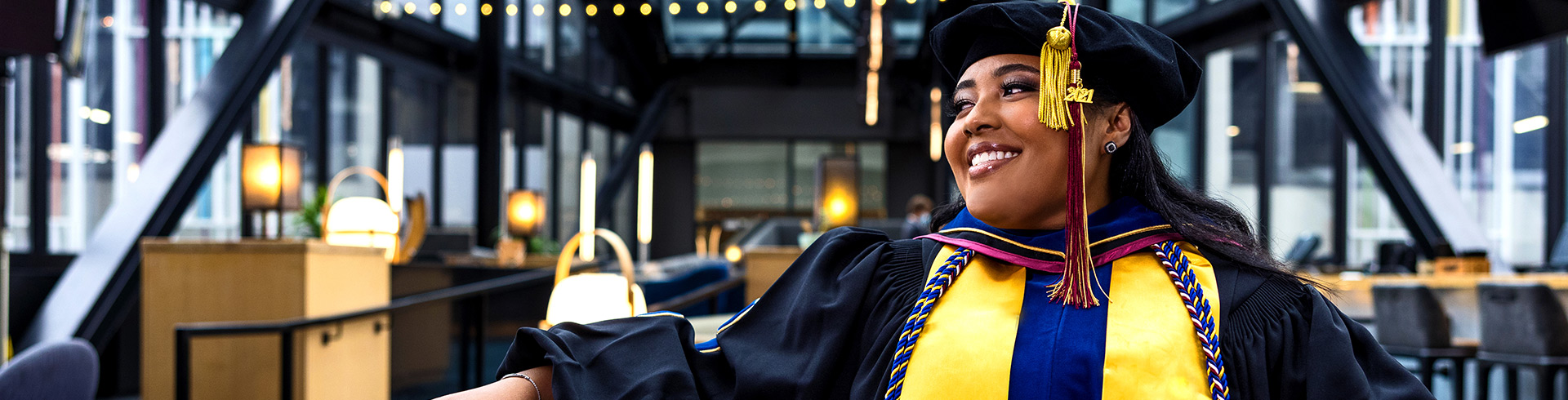 Woman in cap and gown ready for graduation