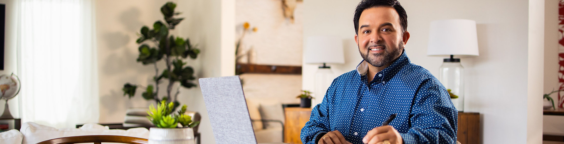 Person sitting at the table working on laptop at home