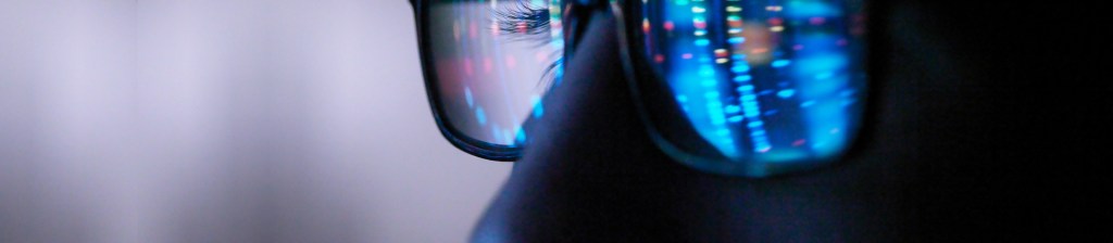 reflection of computer on persons eyeglasses