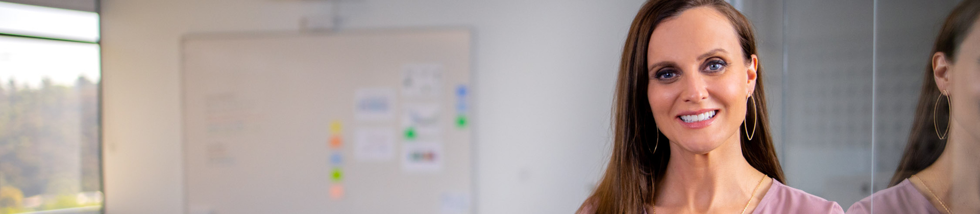 woman in office with whiteboard in the background