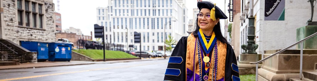 Woman standing outside it regalia