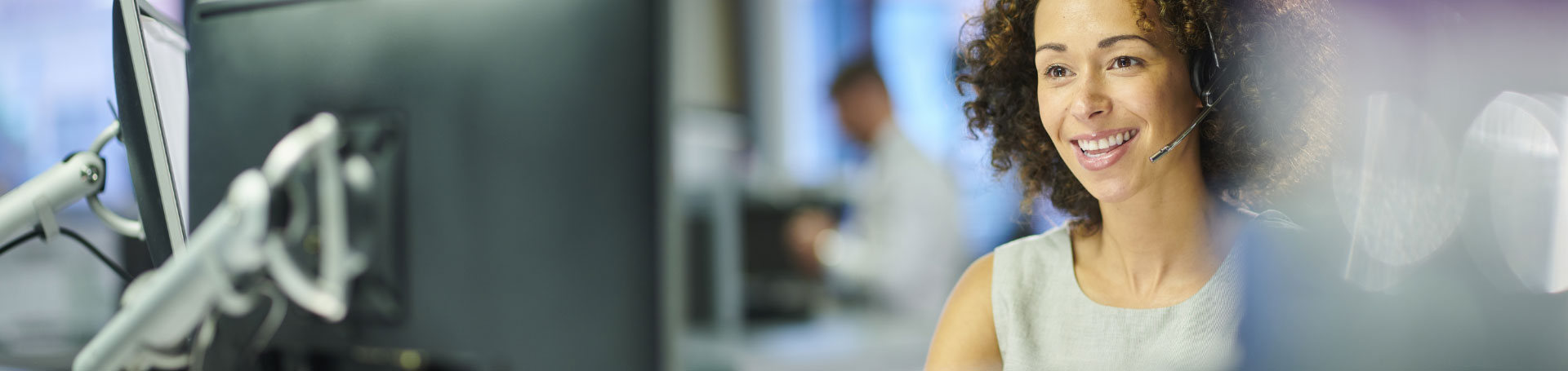 woman wearing a headset working on computer