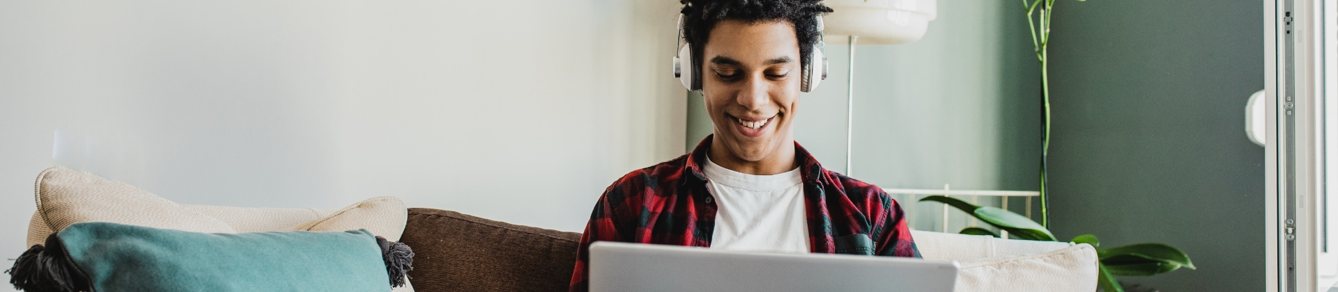 Person working on laptop with headphones on