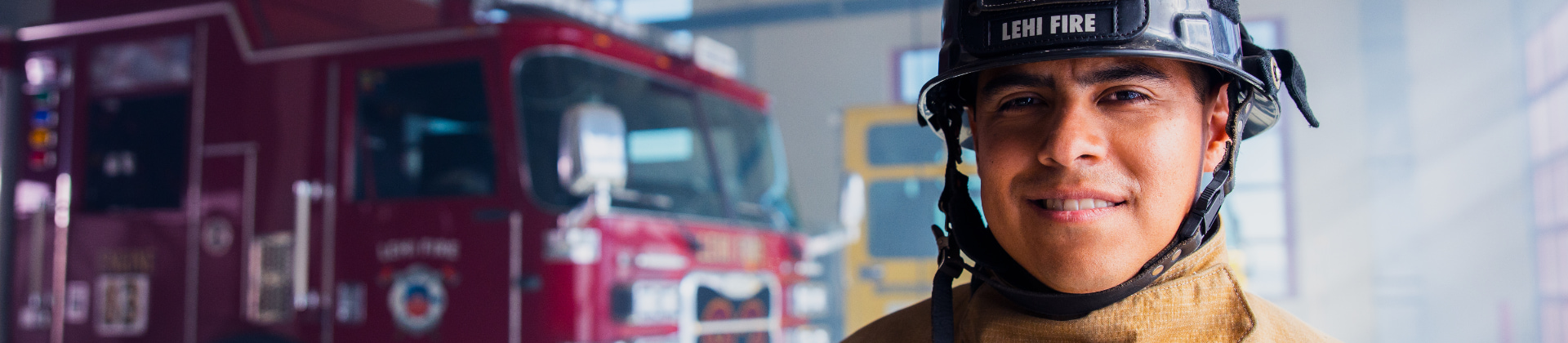 fireman standing in front of firetruck 