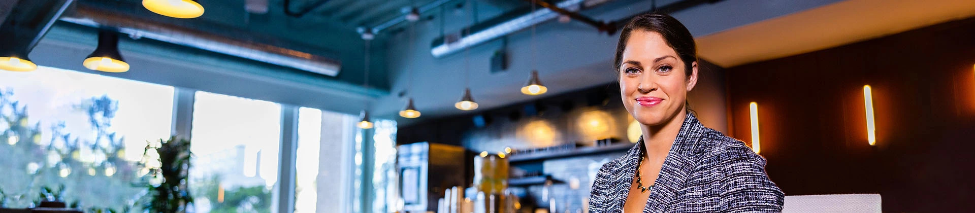 woman in a coffee shop smiles at the camera