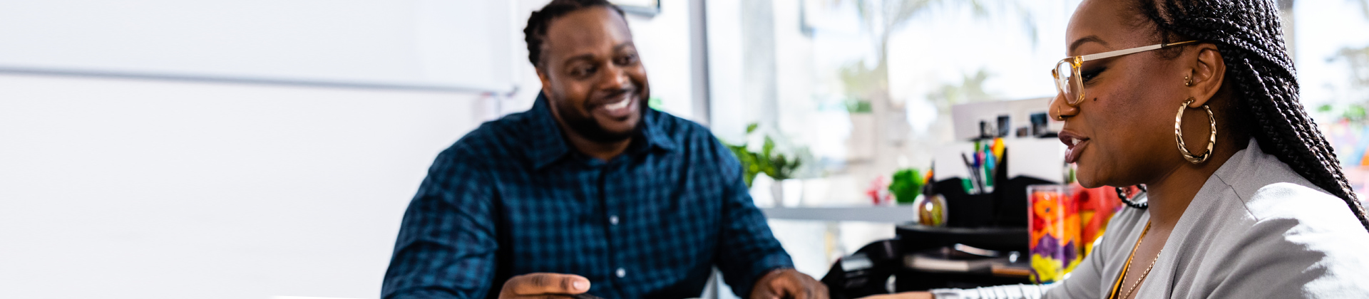 two people talk in an office