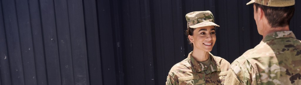 two military servicemembers talk to each other