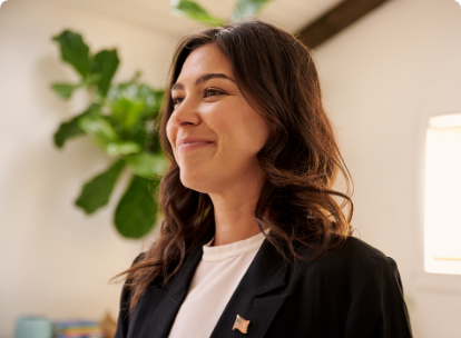 woman smiling with American flag pin