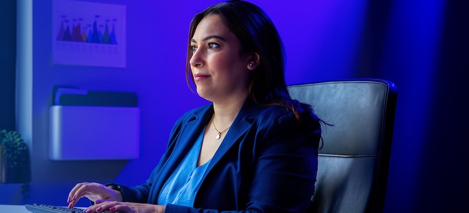 person sitting at desk typing on computer